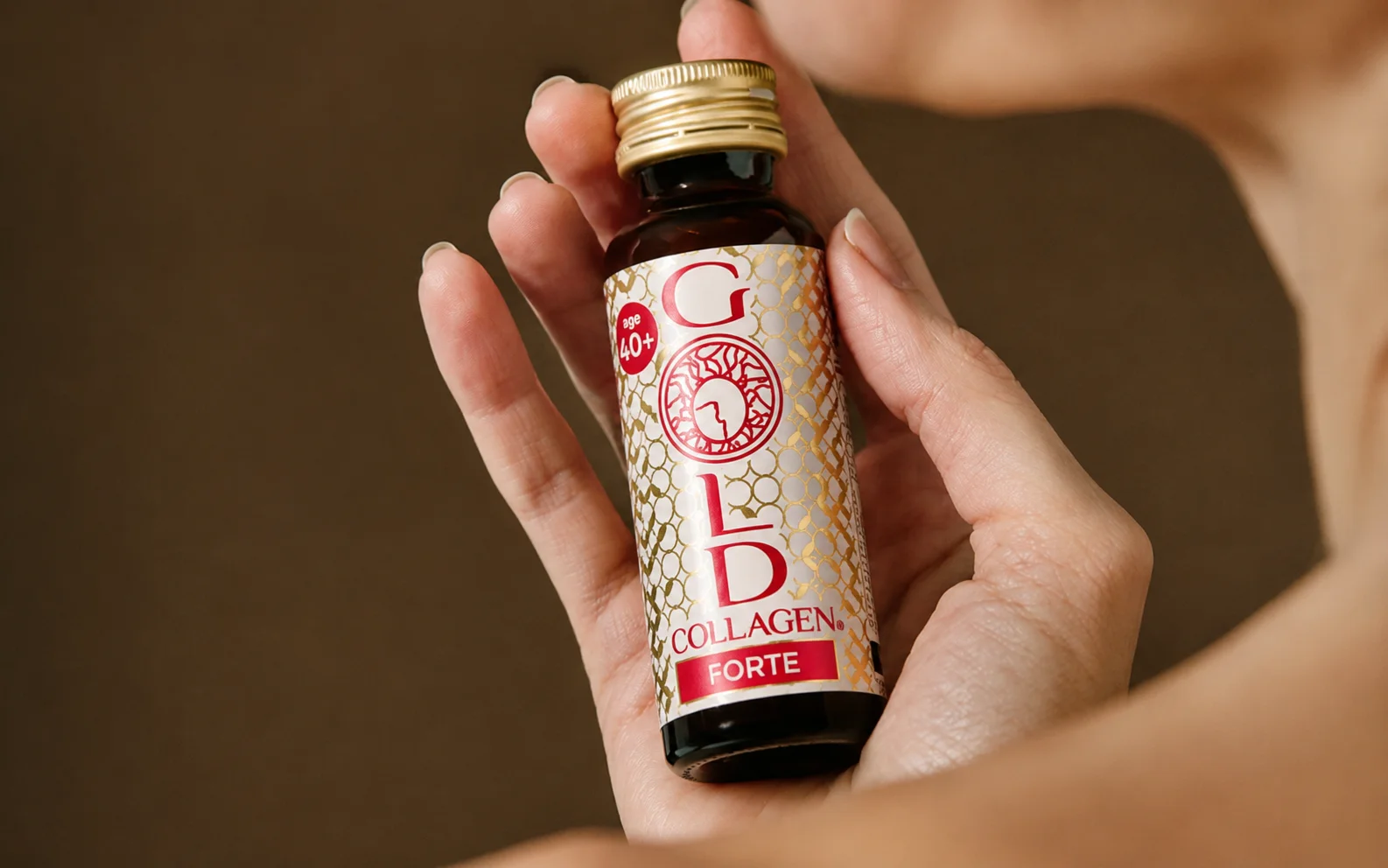 Gold Collagen 1 Gold Collagen liquid supplement bottle held in hand