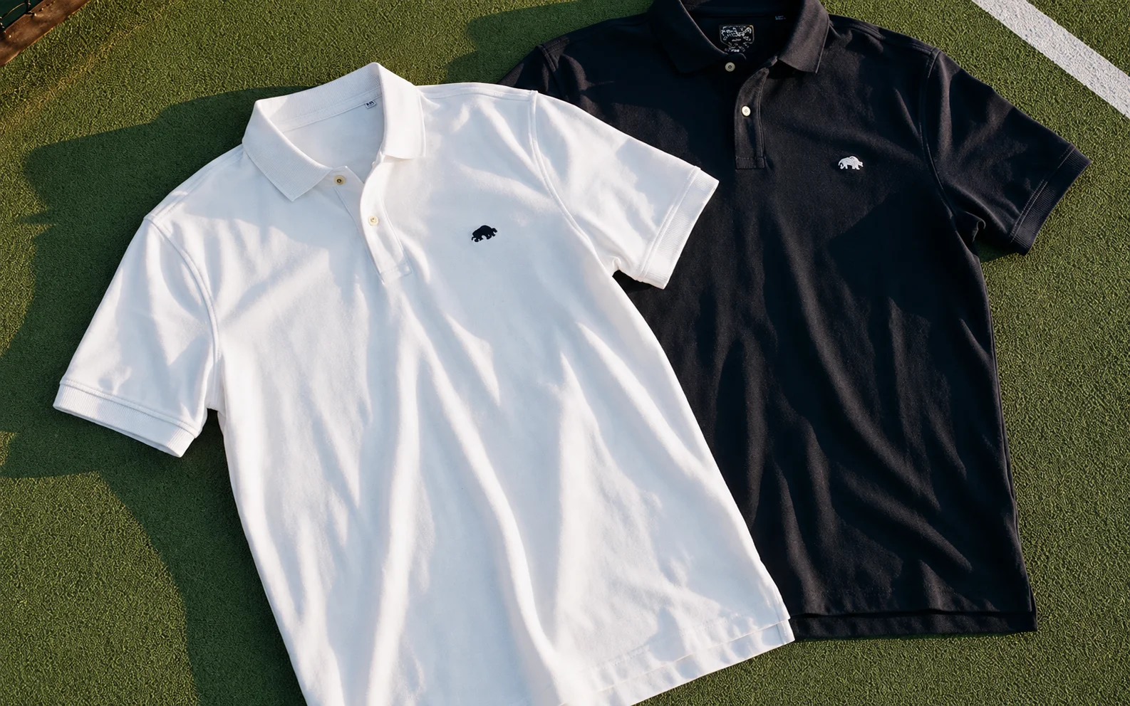 Raging Bull polo shirt laid on grass